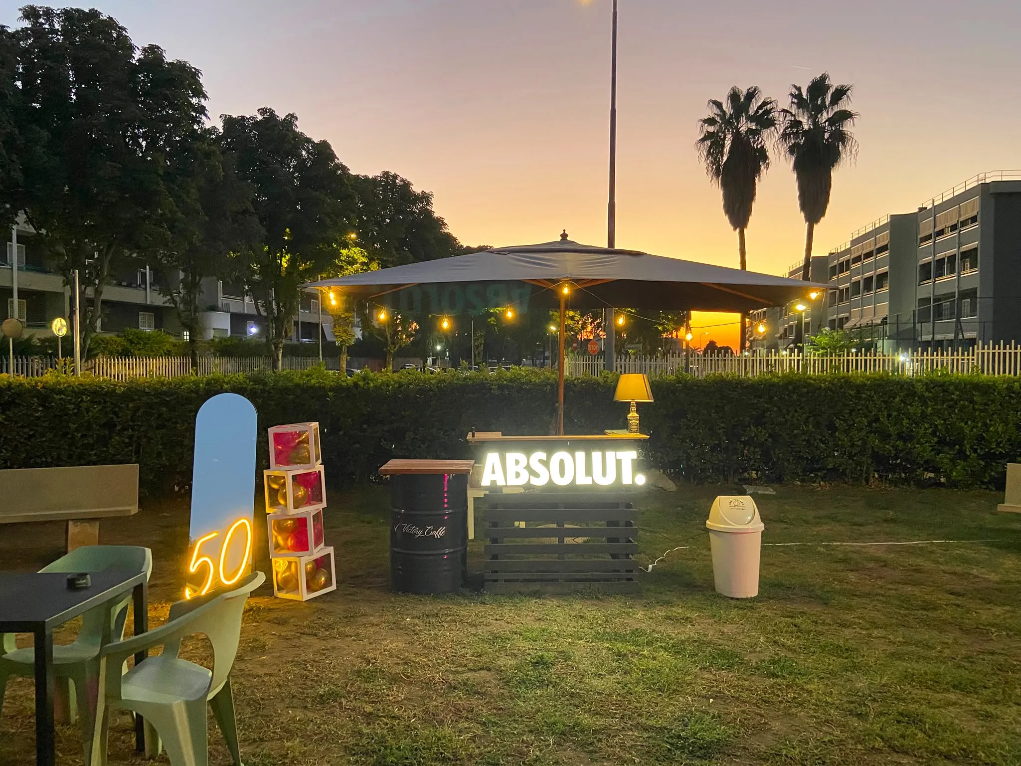 Il bar all’aperto del Victory Chalet al tramonto, sotto l’ombrellone con le lucine accese